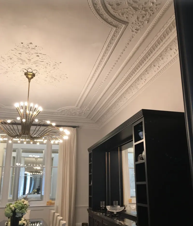 Restored ornate ceiling with brass chandelier in a London home decorated by Whitecrest