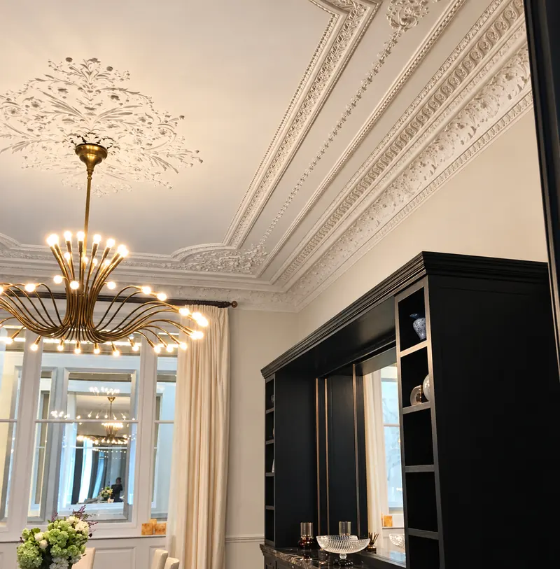 Black lacquered cabinetry and restored cornicing